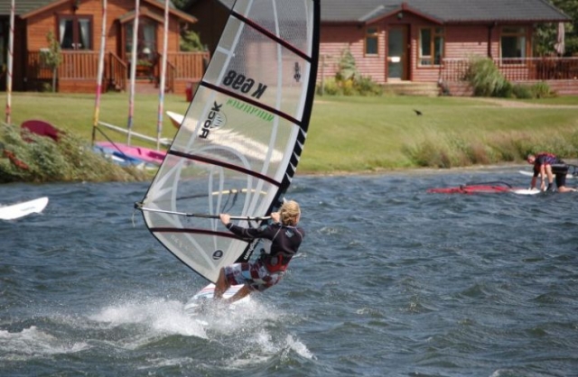 A young boy windsurfing